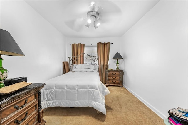 bedroom featuring ceiling fan and light carpet