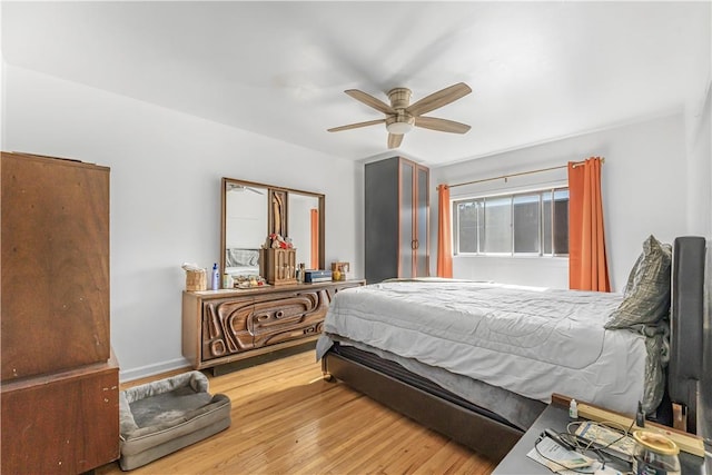 bedroom with ceiling fan and light wood-type flooring