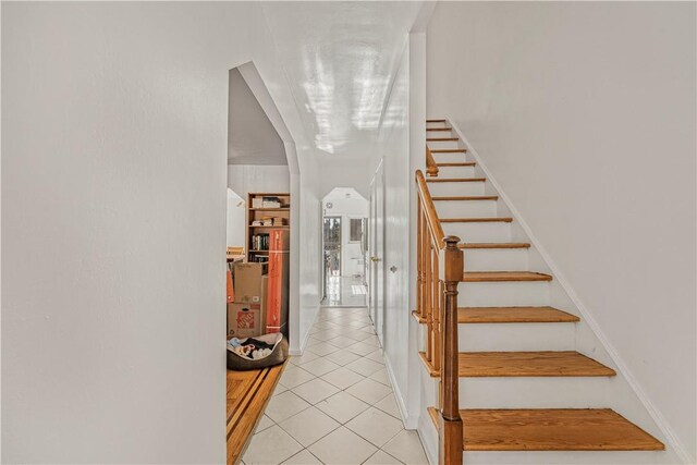 stairway featuring tile patterned flooring