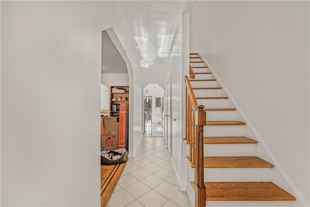 staircase featuring tile patterned flooring