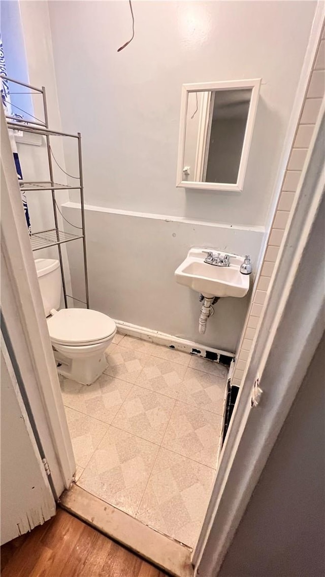 bathroom with sink, wood-type flooring, and toilet