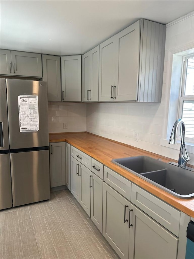 25 Mechanic St, Port Jervis, NY 12771 - kitchen with freestanding refrigerator, butcher block countertops, a sink, gray cabinets, and tasteful backsplash