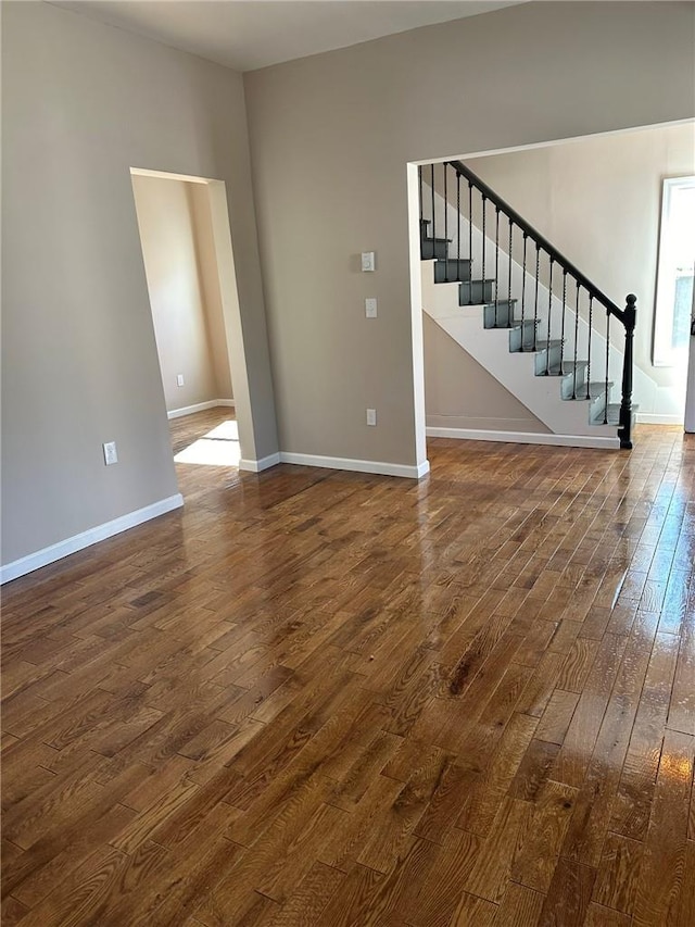 unfurnished living room with dark hardwood / wood-style flooring