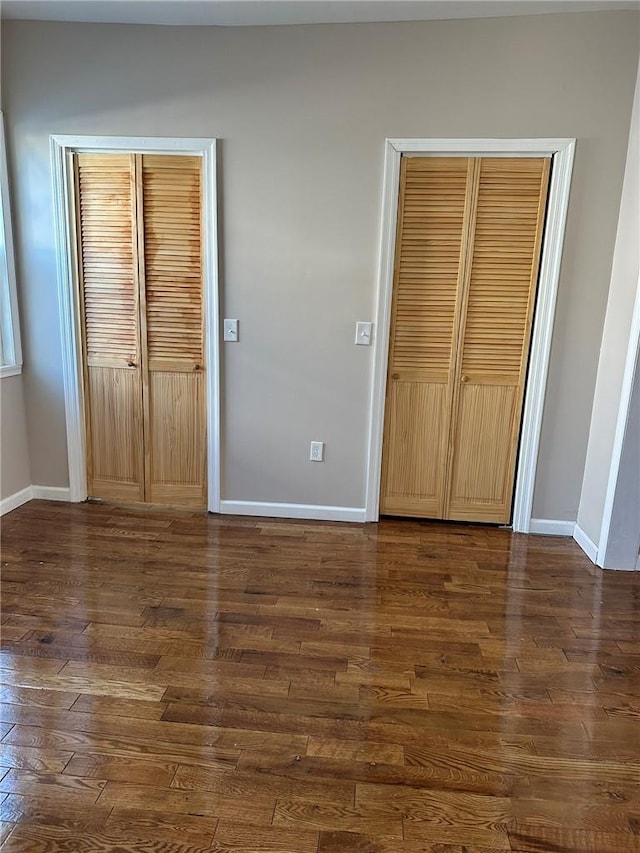 unfurnished bedroom featuring dark hardwood / wood-style floors and a closet