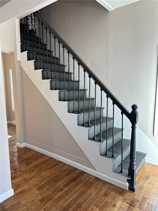 stairs featuring hardwood / wood-style floors