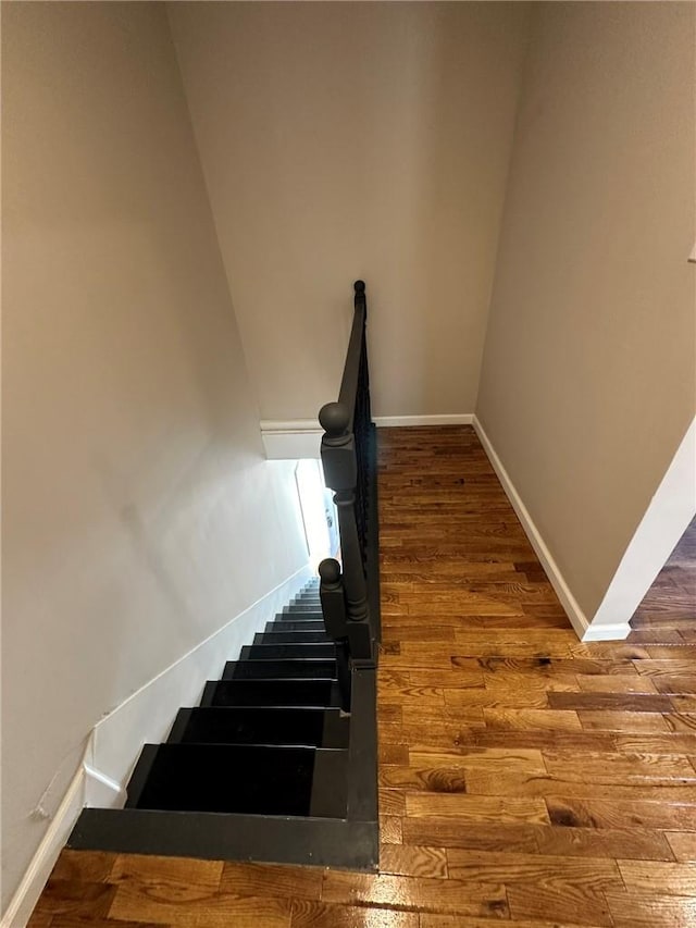 stairs featuring wood-type flooring