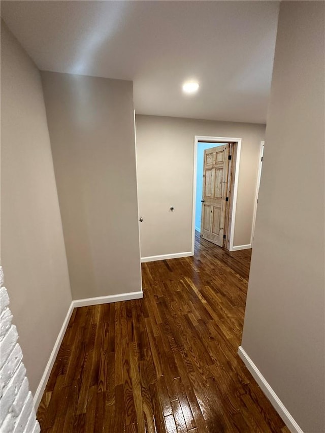 hallway with dark wood-type flooring