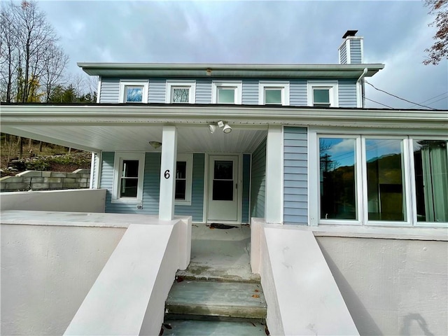 view of exterior entry with a porch