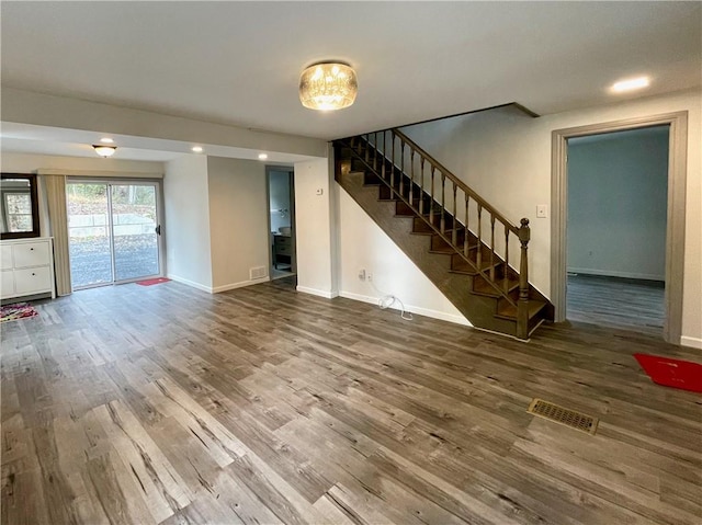 unfurnished living room featuring wood-type flooring