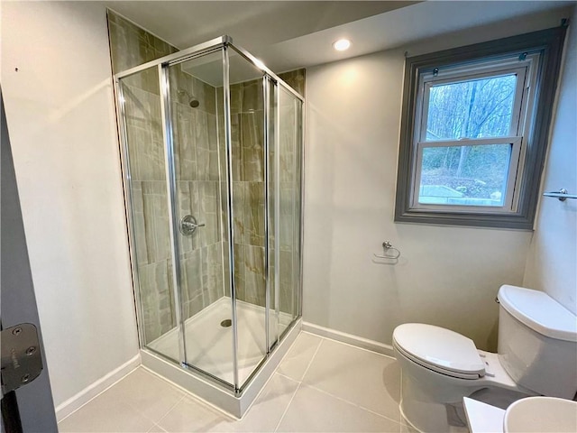 bathroom with tile patterned flooring, toilet, and an enclosed shower