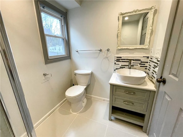 bathroom featuring toilet, vanity, backsplash, and tile patterned floors