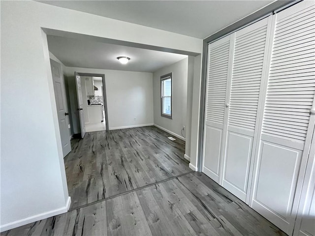 unfurnished bedroom featuring light hardwood / wood-style flooring and a closet