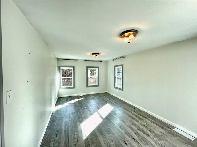 spare room with wood-type flooring