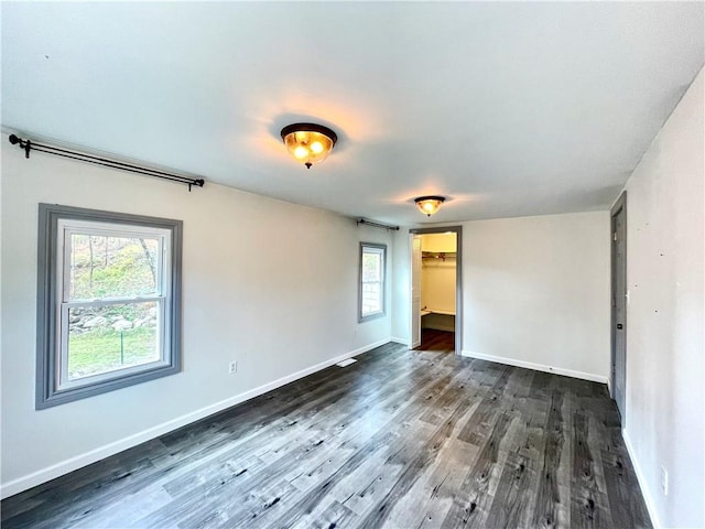 spare room with dark hardwood / wood-style flooring