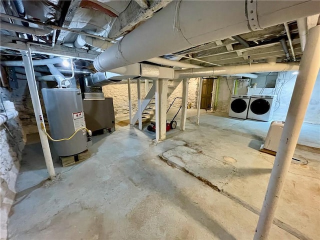 basement with water heater and independent washer and dryer