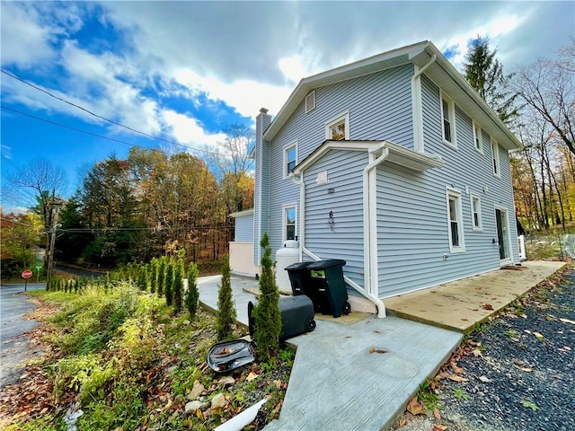 view of side of property with a patio