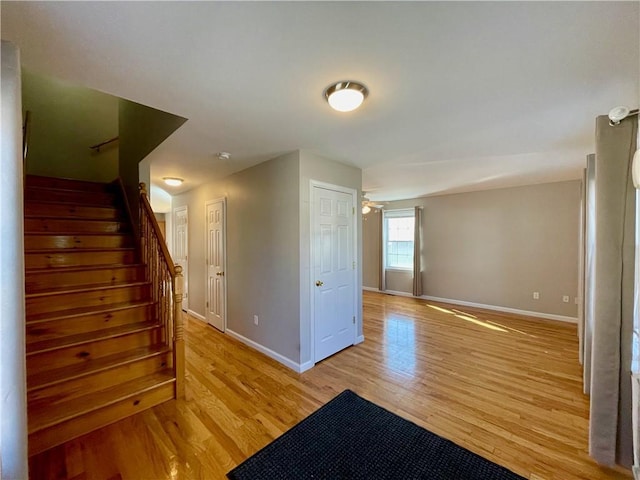 interior space with ceiling fan and light hardwood / wood-style flooring