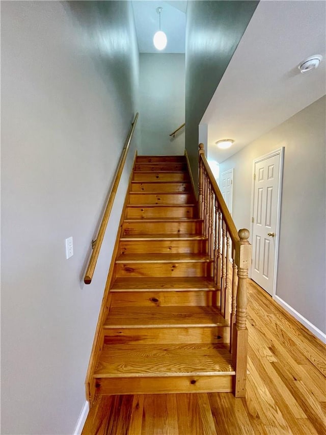 staircase featuring hardwood / wood-style flooring