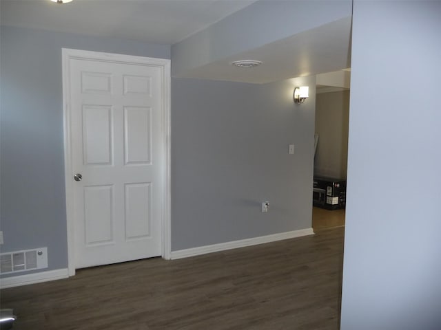 spare room featuring dark wood-type flooring