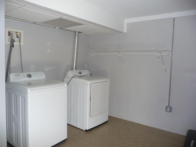 clothes washing area with washer and clothes dryer