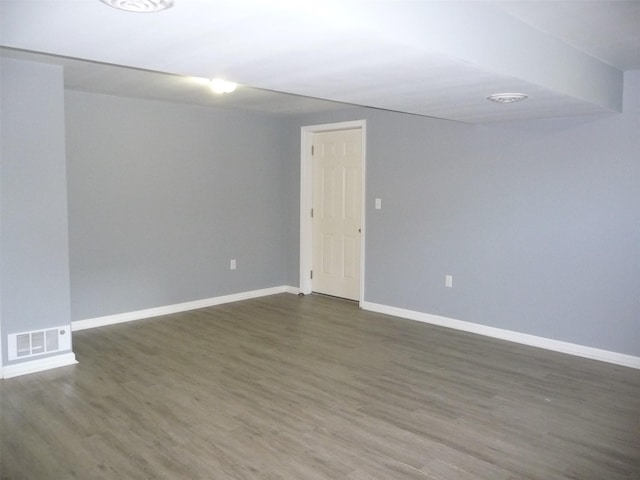 spare room featuring dark hardwood / wood-style floors