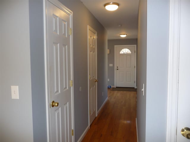 hallway with dark hardwood / wood-style flooring