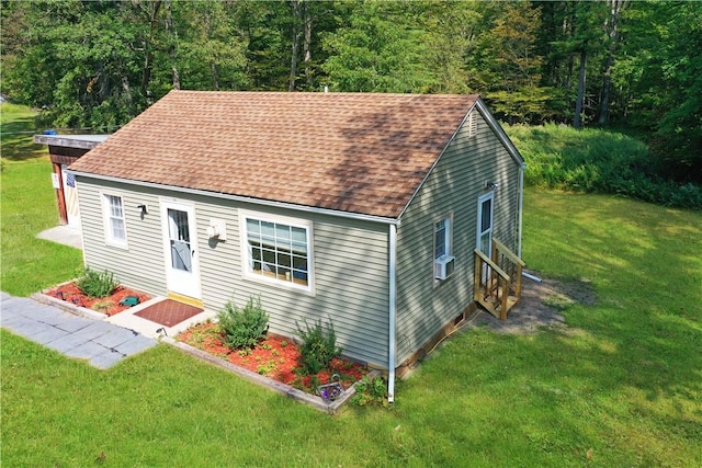 view of front of home featuring a front lawn and cooling unit