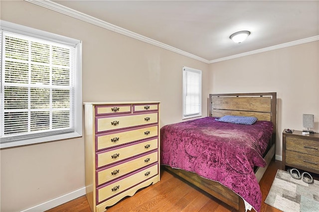 bedroom with hardwood / wood-style floors and ornamental molding