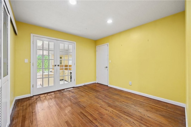 unfurnished room with french doors and hardwood / wood-style floors