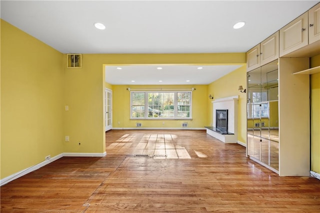 unfurnished living room with light hardwood / wood-style flooring