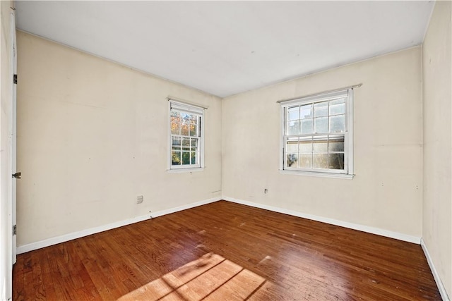 spare room with hardwood / wood-style floors