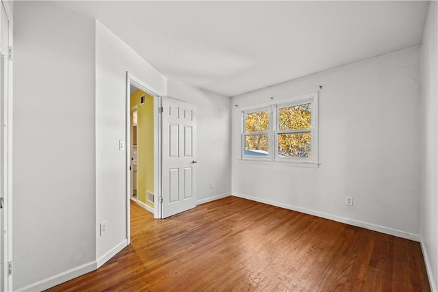 unfurnished room featuring wood-type flooring