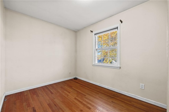 unfurnished room with wood-type flooring