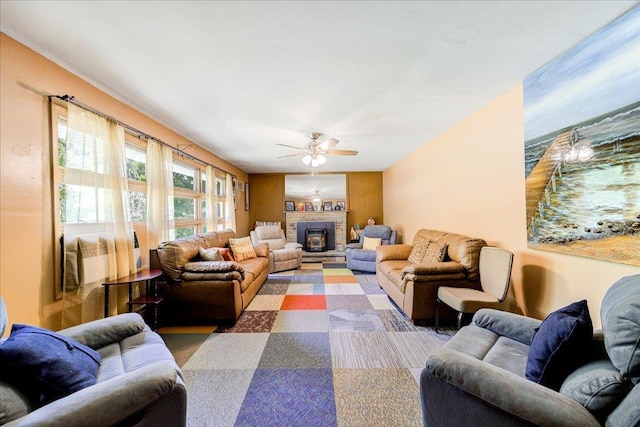 living room featuring ceiling fan and a fireplace