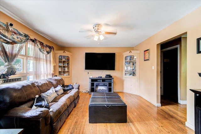 living room with cooling unit, ceiling fan, and hardwood / wood-style floors