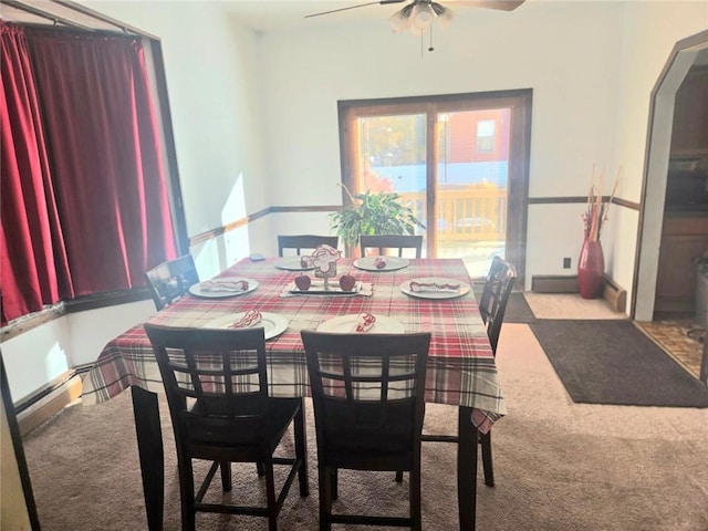 carpeted dining area featuring ceiling fan