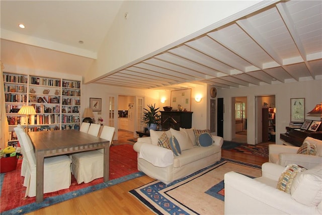 living room with hardwood / wood-style floors and lofted ceiling with beams