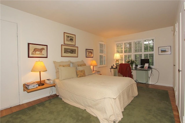 bedroom with dark hardwood / wood-style floors