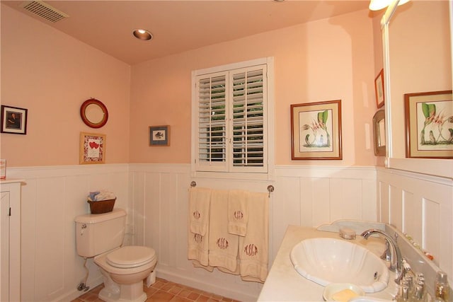 bathroom featuring tile patterned floors, vanity, and toilet