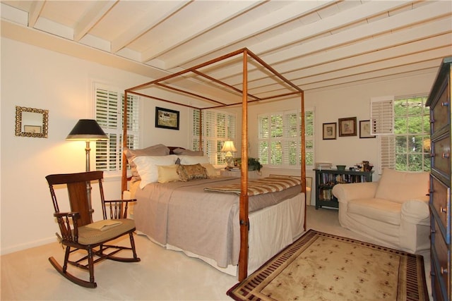 carpeted bedroom featuring beam ceiling