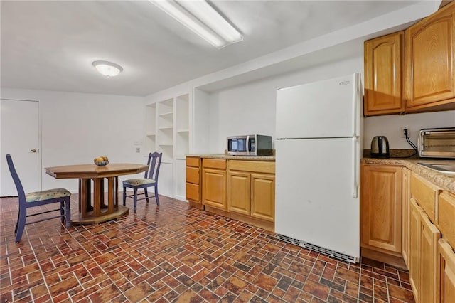 kitchen with white refrigerator and sink