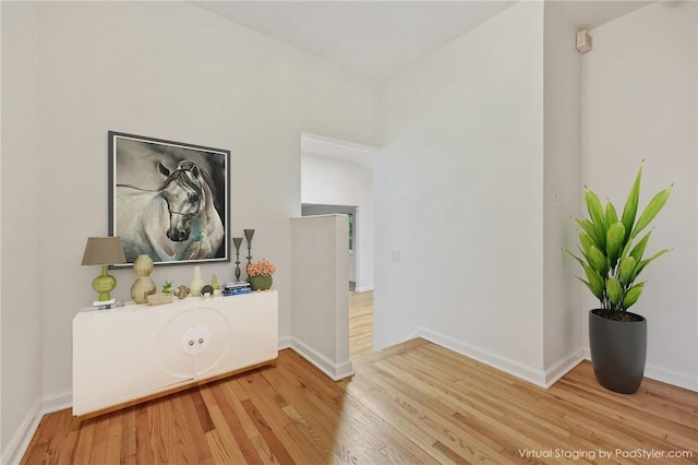 corridor with hardwood / wood-style flooring