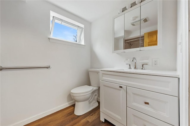 bathroom featuring vanity, hardwood / wood-style flooring, and toilet