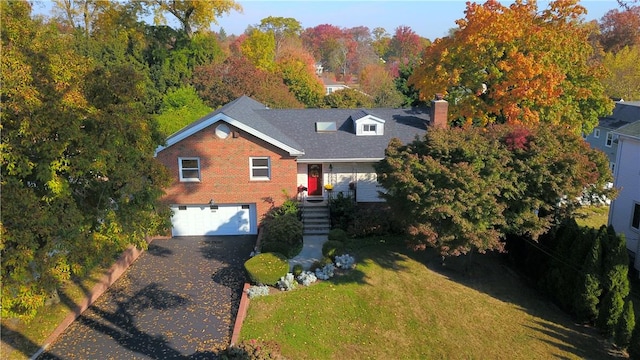 view of front of property with a front yard and a garage