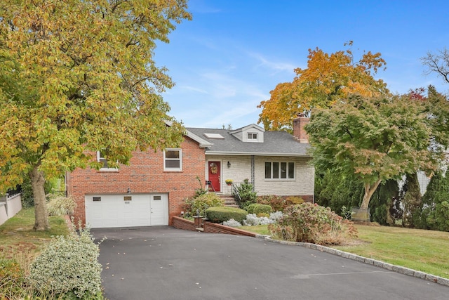 view of front of house with a garage and a front yard