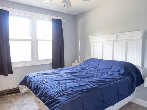 tiled bedroom with ceiling fan