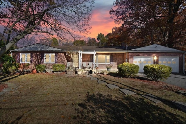 single story home with a lawn and a garage