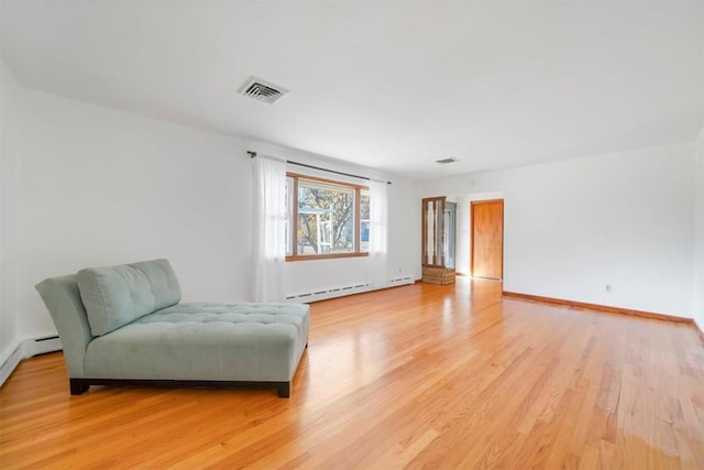 sitting room featuring light hardwood / wood-style flooring and a baseboard radiator