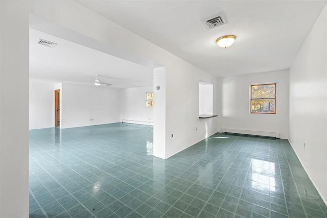 tiled empty room featuring ceiling fan and a baseboard radiator