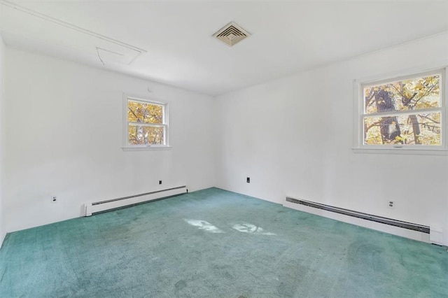 spare room featuring carpet flooring and baseboard heating